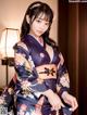 A woman in a kimono posing for a picture.