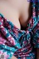 A close up of a woman's breasts wrapped in a scarf.