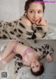 A woman laying on a bed wearing a leopard print blanket.